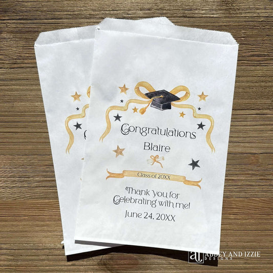 Graduation favor bags, personalized with the guest of honors name and event date. Adorned with a gold ribbon, gold and black stars and black graduation cap. Bags can be used for sweet treats, take home thank you gift, cookies, candy or perfect for utenisl bags.