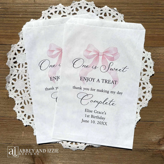 Celebrate your little one's special day with these charming , Girls Birthday Favor Bags with a Pink Bow printed on white bags , personalized for the guest of honor.