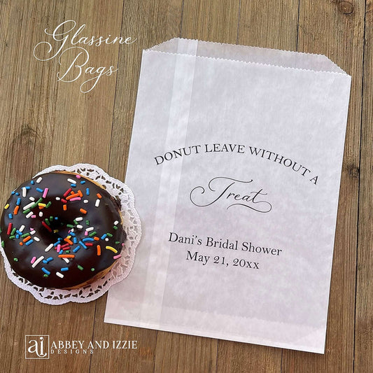Bridal shower donut bags personalized for the bride to be. Our glassine bags are grease resistant and perfect for donut bars, donut favors or a donut wall. Larger than most donut bags these will be a hit as a party favor. Each printed 'donut leave without a treat' with the brides name, bridal shower and date.