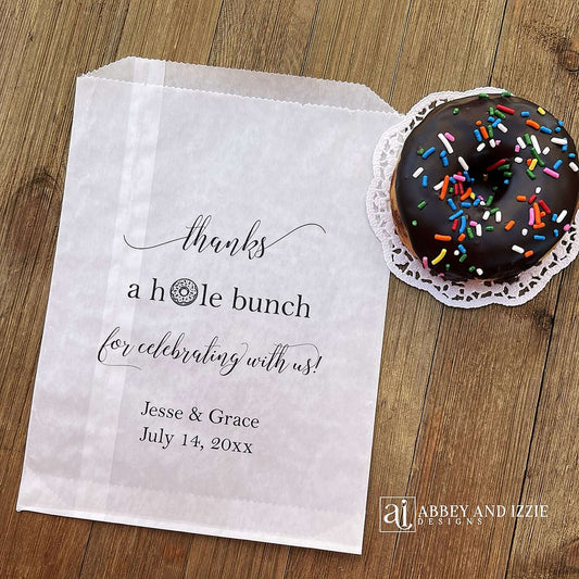 Our personalized wedding donut bags will add a special touch to your donut bar. Each bag is printed 'thanks a hole bunch for celebrating with us!' with the bride and grooms name and wedding date. Bags are glassine and grease resistant. Also great for donut walls.