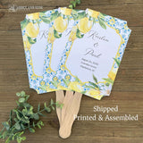 Mediterranean Wedding Program Fans, adorned with blue tiles and lemons. Printed on white card stock, two sided with handle hidden between. Wedding program on the back on the fans, front is personalized for the bride and groom.