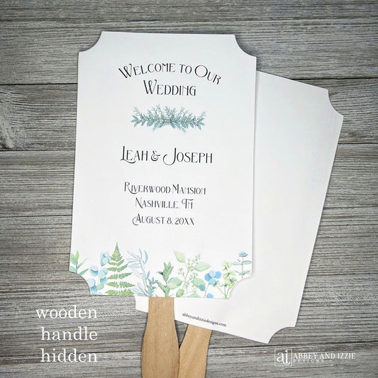 Greenery Wedding Favor Fans personalized and shipped assembled. White fans with bride and grooms names, date and wedding location. Delicate greenery printed at the bottom, corners are cut out, wooden handle is hidden between layers.