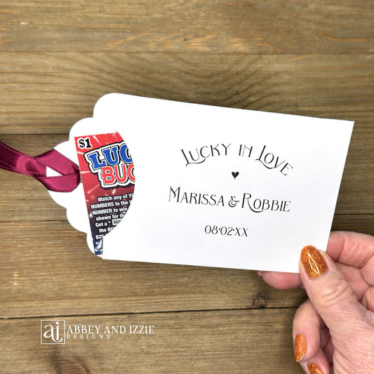 Lucky In Love Wedding Lotto Favors, personalized for the bride and groom. Slide a lottery ticket these adorable envelopes for a fun wedding favor. rinted on white cardstock with your choice of ribbon color.
