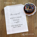 Our personalized glassine bridal shower favor bags are perfect for a candy bar, cookie bar, donut bar or brownies.  Each translucent bag comes printed with 'love is sweet enjoy a treat thank you for making my day complete.'  Personalized with the brides name and event date.  Bags are glassine and grease resistant.