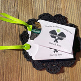 Personalized Pickleball Party Favors that will be fun for all your guests. Adonred with a pickleball and paddles these are personalized for the event. Printed on white cardstock with green ribbon attached. Slide a lottery ticket in the open end and see who wins