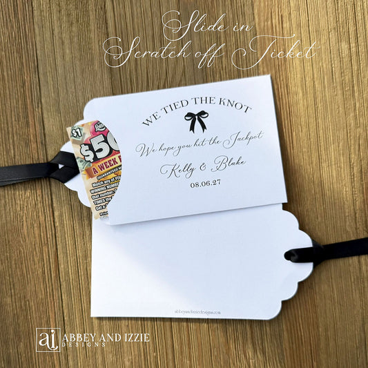 Fun wedding favors personalized, 'we tied the knot we hope you hit the jackpot'. Lottery ticket wedding favors, slide a scratch off in the open end and see who wins. Personalized for the bride and groom with your choice of ribbon colors.