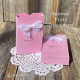 Personalized pink favor boxes with bow for the guest of honor.  Made from pink card stock with white ribbon and bow around the top which comes attached.