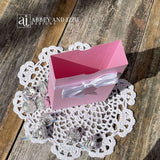 Personalized pink favor boxes with bow for the guest of honor.  Made from pink card stock with white ribbon and bow around the top which comes attached.