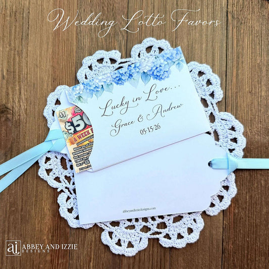 Our blue hydrangea wedding favors are made from white cardstock, adorned with delicate hydrangeas at the top, printed with 'Lucky In Love' with the brdie and grooms names and wedding date. Each comes with a light blue ribbon attached for an elegant touch. Guest will find these lotto favors fun with hopes of winning something big.