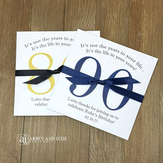 Reveal the fun with scratch-off birthday party favors that double as entertainment and keepsakes; Slide open the back side and enclose scratch off ticket for each guest, a fun and interactive party favor. Ideal for milestone birthdays, personalize with names, date and sweet message Each envelope is printed on sturdy white cardstock with your choice of number and ribbon color to match you party theme. Shipped to you assembled with ribbon. Scratch off tickets are NOT included.