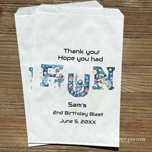 Blast off into party perfection with these Space Birthday Favor Bags! Designed to delight young astronauts and space enthusiasts, each bag features vibrant cosmic imagery including planets, stars, and rockets. Perfect for filling with small toys, candy, or treats, these favor bags add an out-of-this-world touch to any birthday celebration. Printed on white bags and personalized for the guest of honor. Text 'Thank you! Hope you had FUN'.