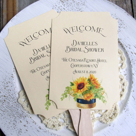 Sunflower Bridal Shower Favor Fans personalized for the bride to be. Fans are printed on ivory cardstock adornerd with a beautiful sunflower motif. Shipped to you assembled and ready for your event. Fans have a wooden handle and are two sided with handle hidden, printing on one side only.