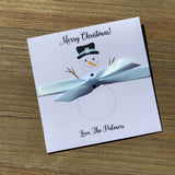 Small Holiday Gift, slide a lotto ticket in for a fun little gift or Holiday party favor.  White envelopes printed with a snowman, Merry Christmas and your name.  Each comes with a light blue ribbon attached.
