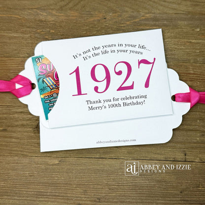 Our 100th birthday party favors are personalized for the guest of honor, your choice of ribbon color and year color. Always a fun ice breaker, slide a scratch off ticket in and see who is the winner! Each 100th birthday favor comes with the year the honoree was born printed in the center with 'It's not the years in your life...it's the life in your years' and happy birthday to the guest of honor. These can be made for any birthday year, 50th, 60th, 70th, 100th your choice. 100th Birthday Party Favors