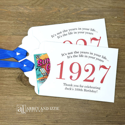 Our 100th birthday party favors are personalized for the guest of honor, your choice of ribbon color and year color. Always a fun ice breaker, slide a scratch off ticket in and see who is the winner! Each 100th birthday favor comes with the year the honoree was born printed in the center with 'It's not the years in your life...it's the life in your years' and happy birthday to the guest of honor. These can be made for any birthday year, 50th, 60th, 70th, 100th your choice. 100th Birthday Party Favors