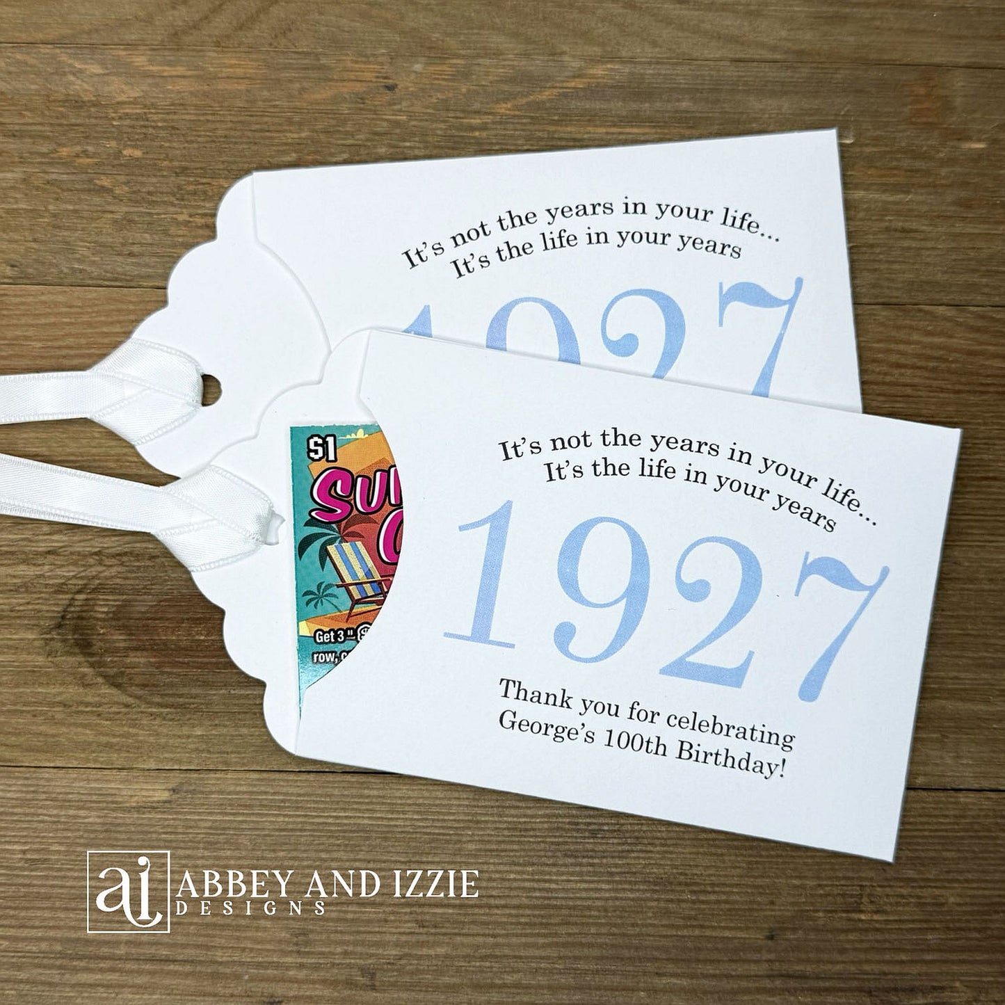 Our 100th birthday party favors are personalized for the guest of honor, your choice of ribbon color and year color. Always a fun ice breaker, slide a scratch off ticket in and see who is the winner! Each 100th birthday favor comes with the year the honoree was born printed in the center with 'It's not the years in your life...it's the life in your years' and happy birthday to the guest of honor. These can be made for any birthday year, 50th, 60th, 70th, 100th your choice. 100th Birthday Party Favors