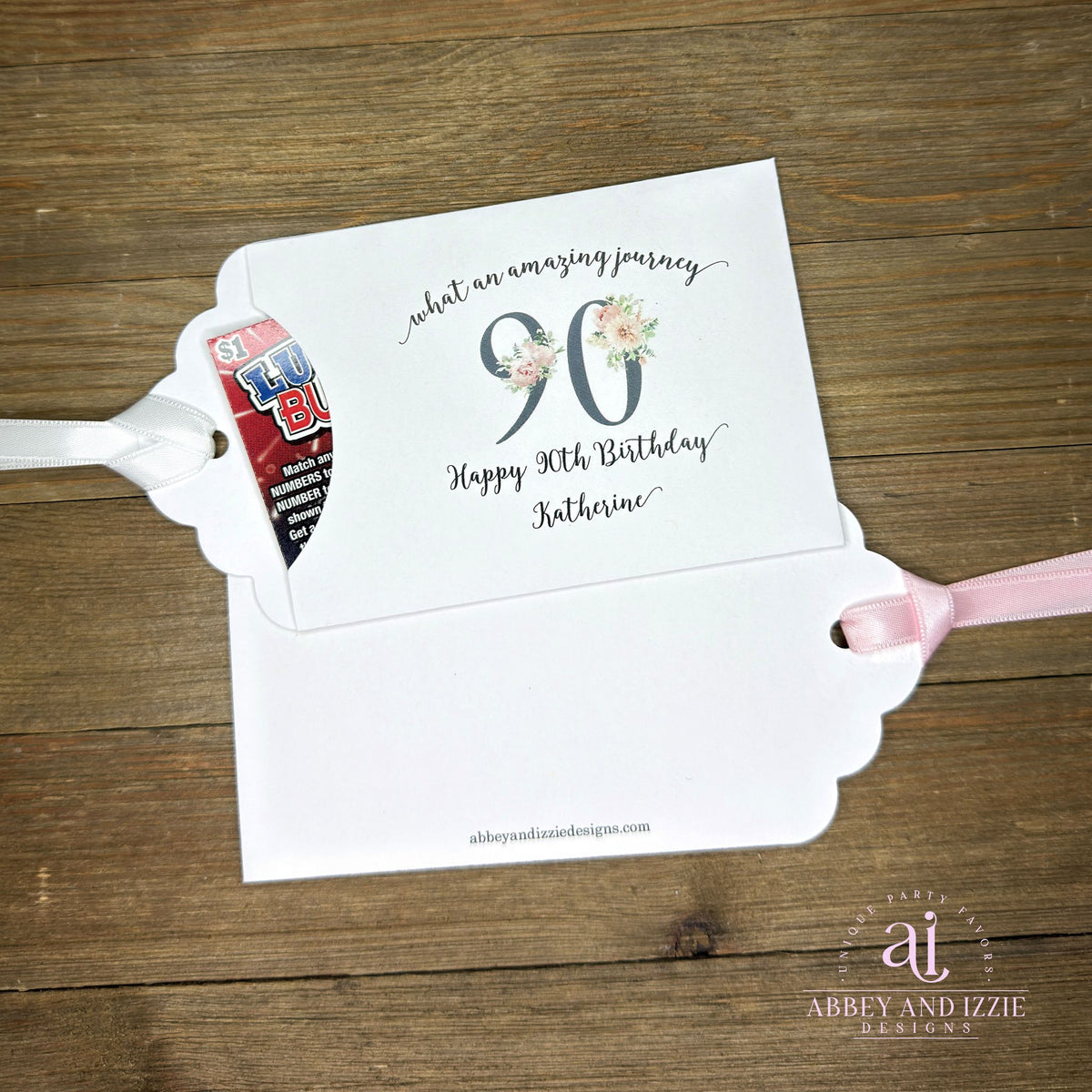 Elegant 90th Birthday Party Favors will add a special touch to your event.  Printed on white card stock with a large 90 in floral font add the guest of honors name for a personal touch.  Your choice of pink, black or white ribbon which comes attached