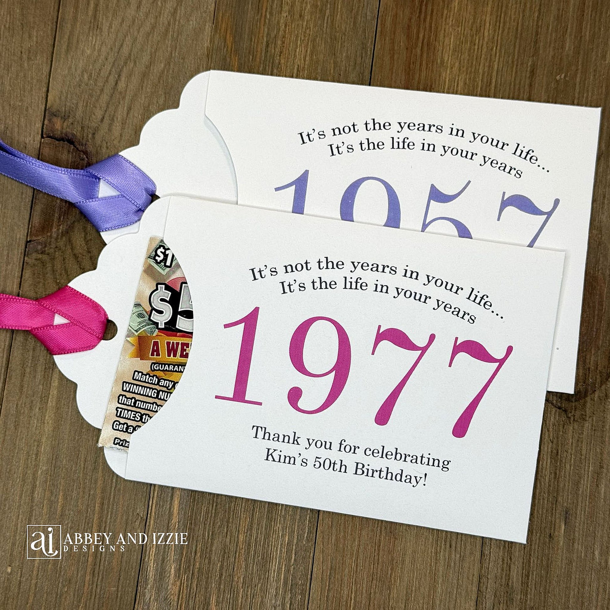Personalized scratch-off birthday favors for adults. Each envelope features a special message with the year the guest of honor was born in color. Including a thank you for celebrating with the us. Works for milestone birthdays, adult parties, and special events see our store for more options. Constructed from white high-quality cardstock with your choice of year color and ribbon color, which comes attached.