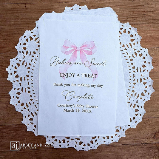 Babies are sweet enjoy a treat thank you for making my day complete. Adorned with a pink bow and personalized for the mother to be these bags are perfect for a candy bar or any sweet treat for your guests.