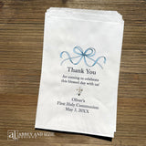 Celebrate your son's First Communion with our personalized First Communion Favor Bags that transform a sacred moment into a cherished memory. Each bag is customized with his name, event date and a sweet thank you.  Printed on white bags with a fun blue bow and a cross.