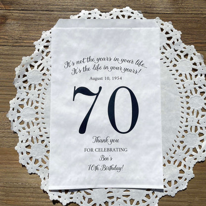 Personalized 70th Birthday Favor Bags, fill them with sweet treats for your guests.  White paper bags printed with a large # 70 and personalized for the guest of honor.  Larger favor bags to hold more treats.  Adult part favor bags that also great for holding a napkin and utensils.