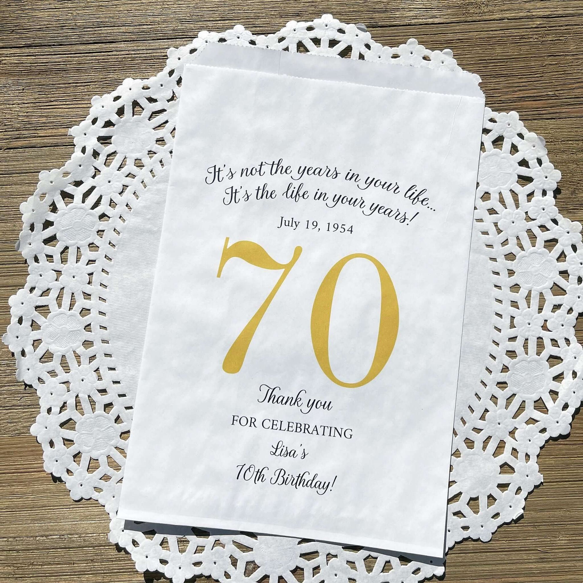 Personalized 70th Birthday Favor Bags, fill them with sweet treats for your guests.  White paper bags printed with a large # 70 and personalized for the guest of honor.  Larger favor bags to hold more treats.  Adult part favor bags that also great for holding a napkin and utensils.