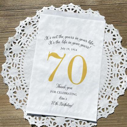 Personalized 70th Birthday Favor Bags, fill them with sweet treats for your guests.  White paper bags printed with a large # 70 and personalized for the guest of honor.  Larger favor bags to hold more treats.  Adult part favor bags that also great for holding a napkin and utensils.