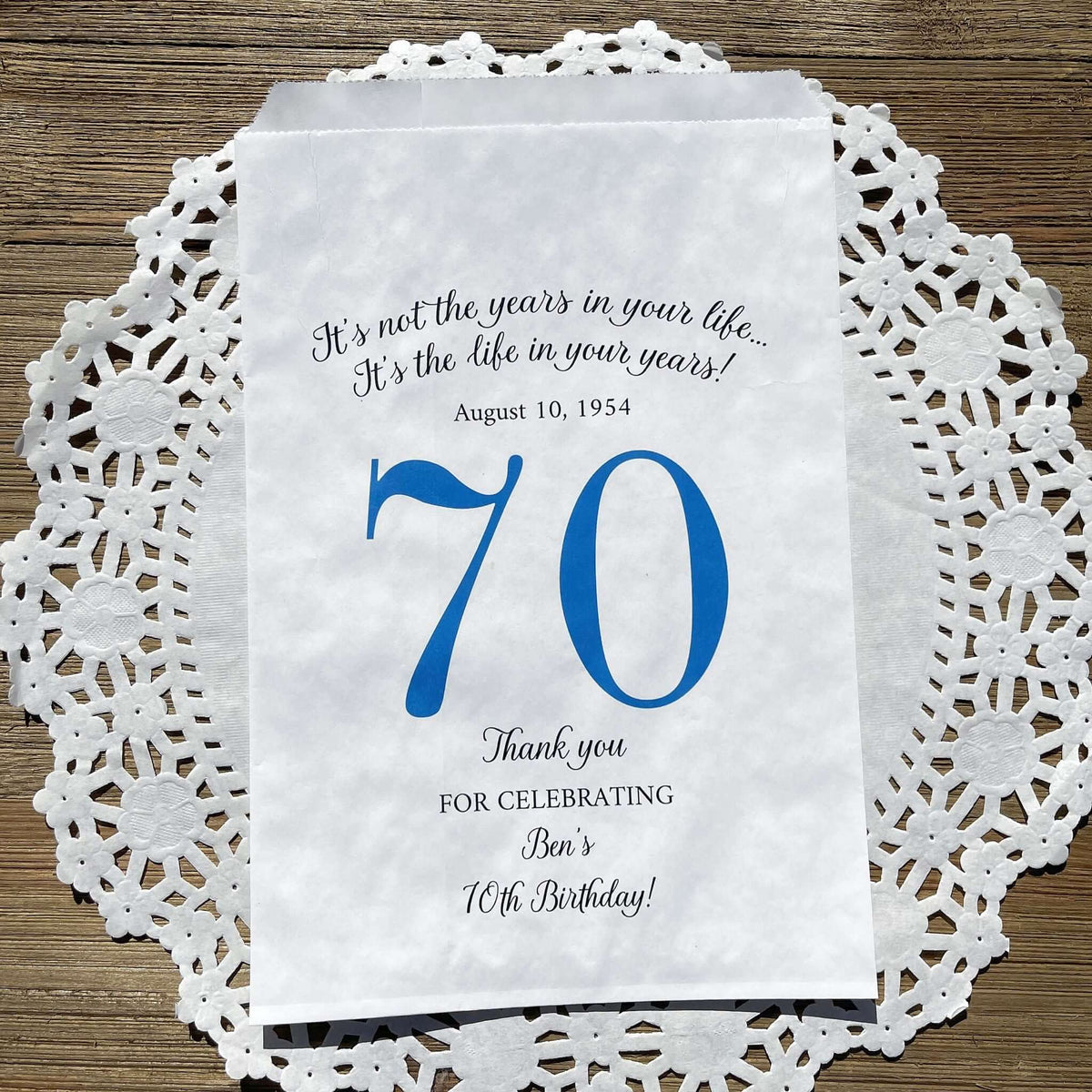 Personalized 70th Birthday Favor Bags, fill them with sweet treats for your guests.  White paper bags printed with a large # 70 and personalized for the guest of honor.  Larger favor bags to hold more treats.  Adult part favor bags that also great for holding a napkin and utensils.