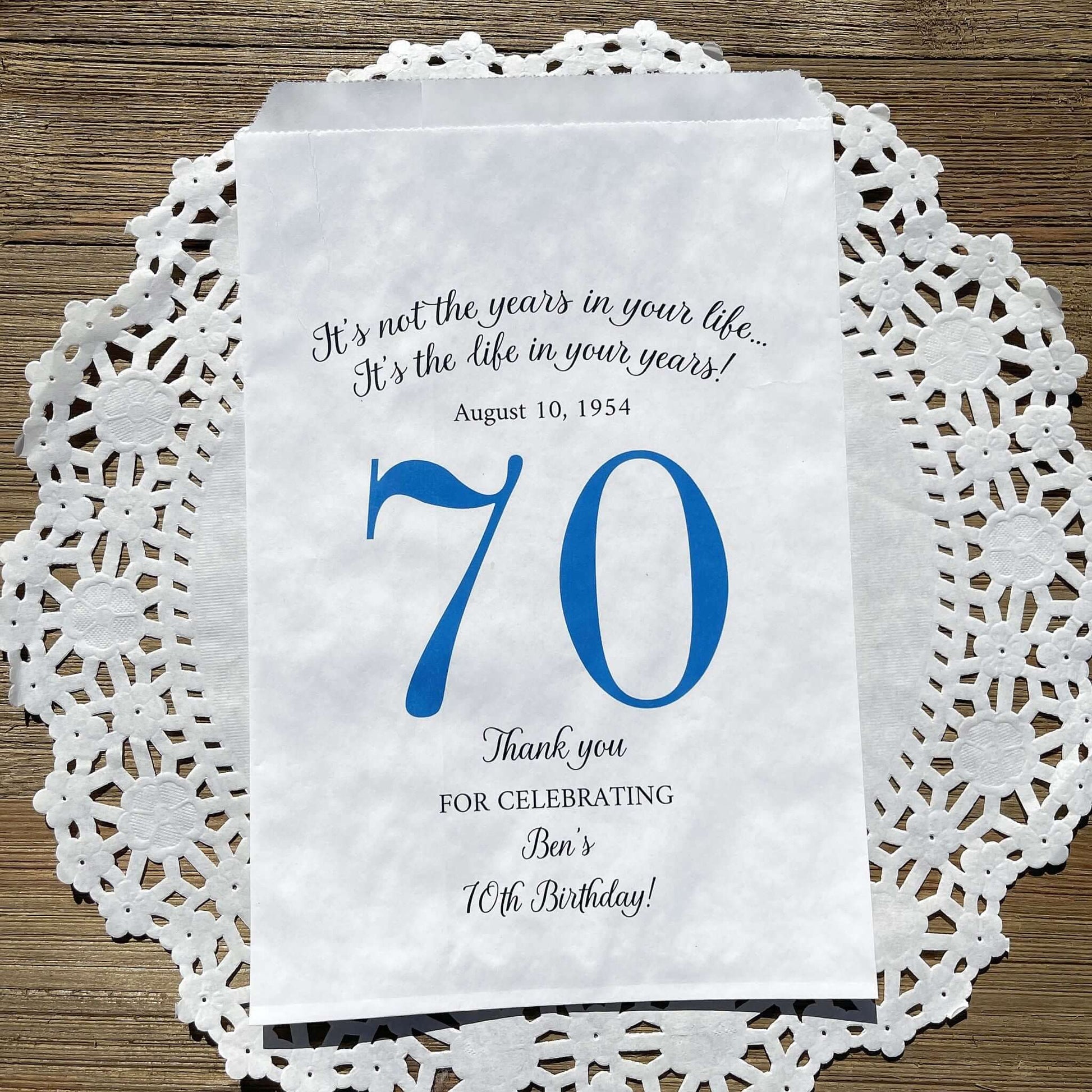 Personalized 70th Birthday Favor Bags, fill them with sweet treats for your guests.  White paper bags printed with a large # 70 and personalized for the guest of honor.  Larger favor bags to hold more treats.  Adult part favor bags that also great for holding a napkin and utensils.