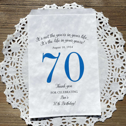 Personalized 70th Birthday Favor Bags, fill them with sweet treats for your guests.  White paper bags printed with a large # 70 and personalized for the guest of honor.  Larger favor bags to hold more treats.  Adult part favor bags that also great for holding a napkin and utensils.