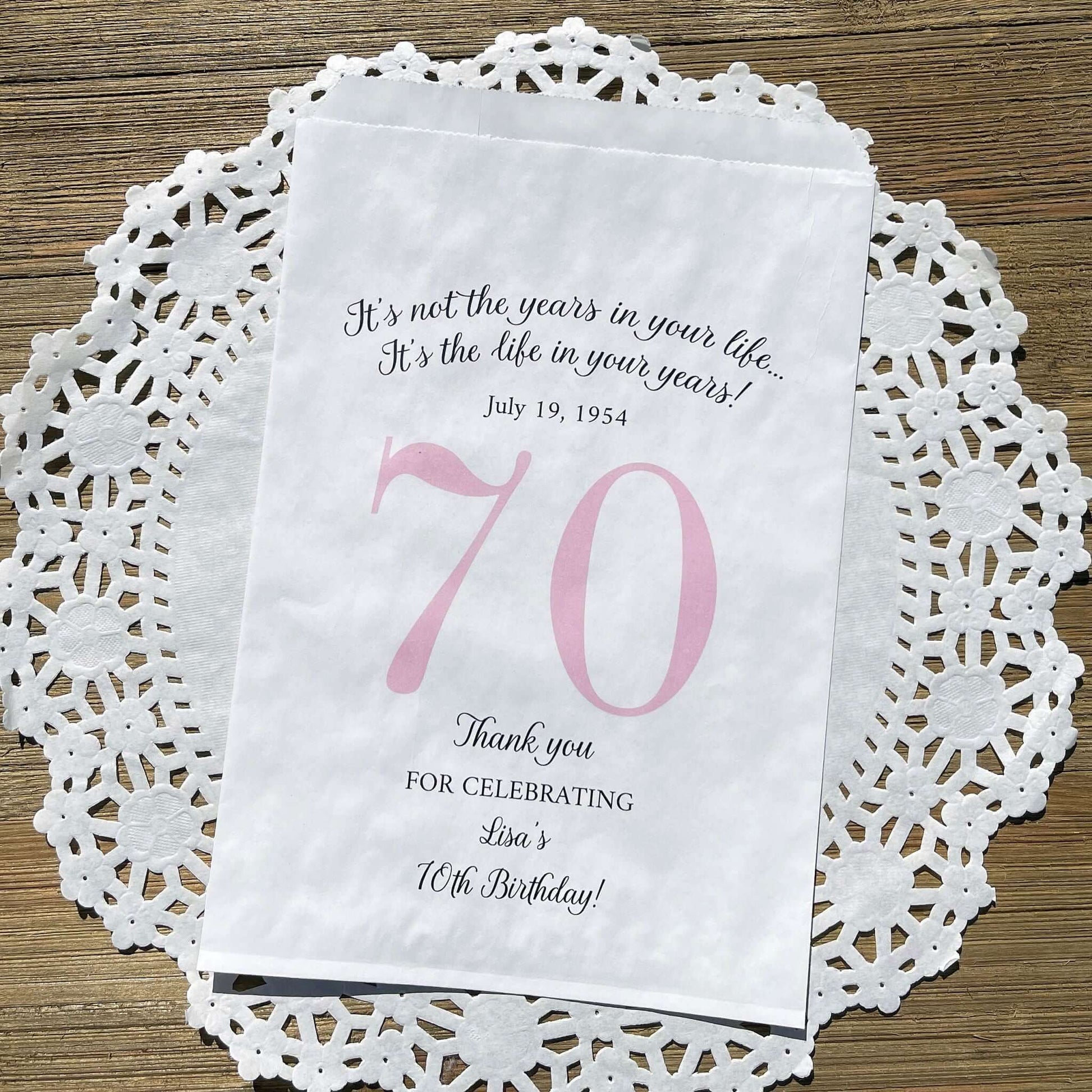 Personalized 70th Birthday Favor Bags, fill them with sweet treats for your guests.  White paper bags printed with a large # 70 and personalized for the guest of honor.  Larger favor bags to hold more treats.  Adult part favor bags that also great for holding a napkin and utensils.