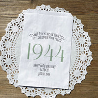 Adult favor bags for any birthday year. White bags with the year the guest of honor was born printed with their birth date. Your choice of colors, adorned with a sweet message.