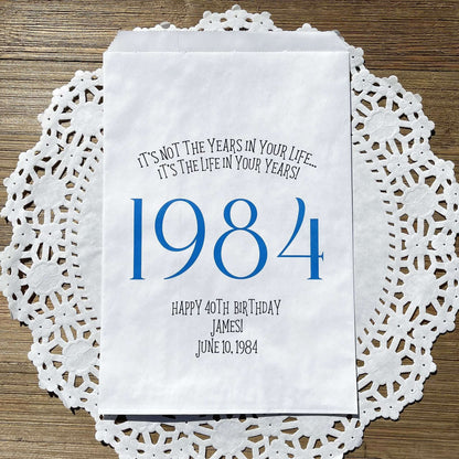 Adult birthday favor bags personalized,  white bags with the year the guest of honor was born printed with their birth date.  Your choice of colors, adorned with a sweet message.  