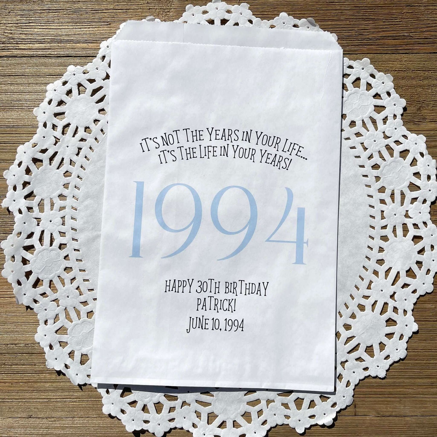 Adult birthday favor bags personalized,  white bags with the year the guest of honor was born printed with their birth date.  Your choice of colors, adorned with a sweet message.  