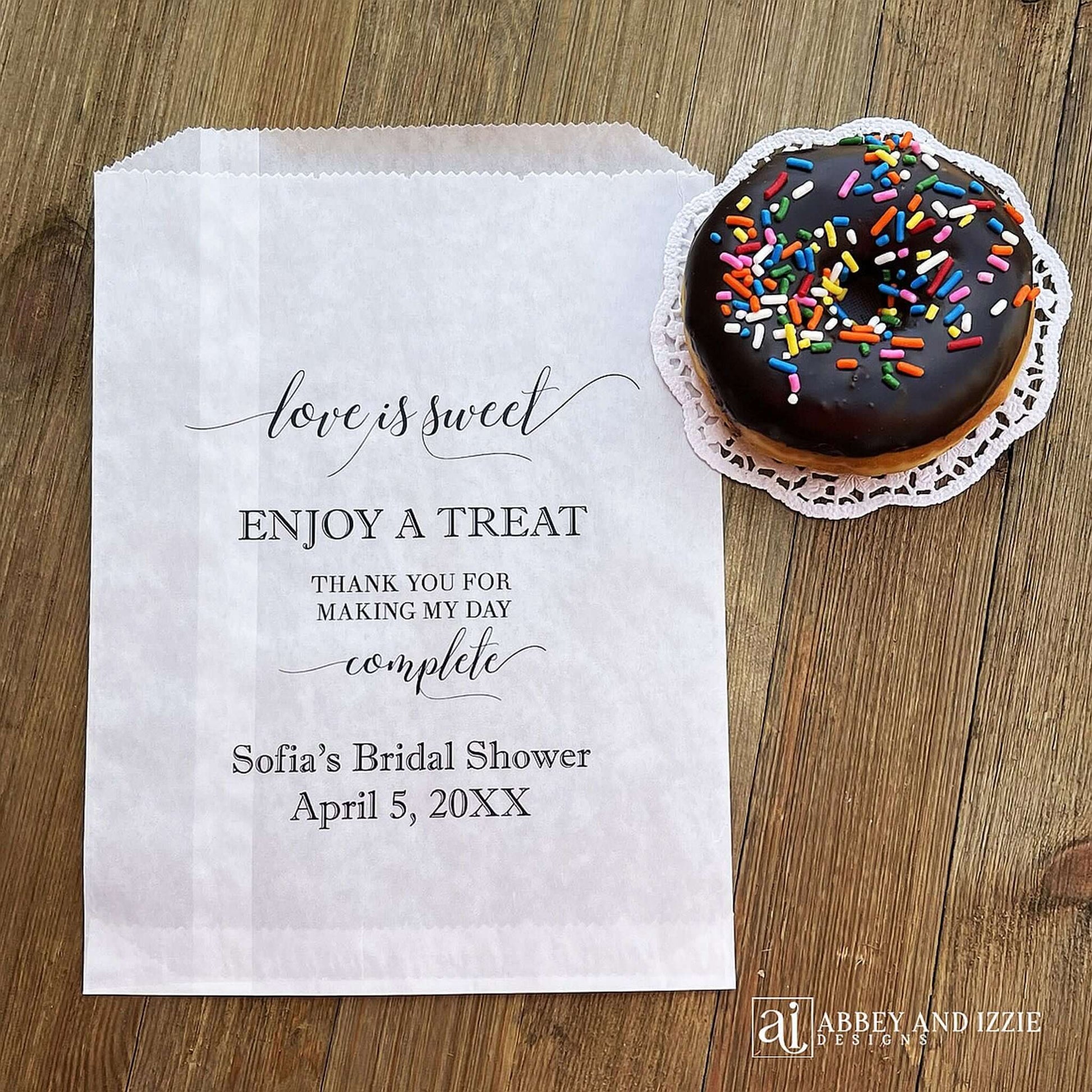Our personalized glassine bridal shower favor bags are perfect for a candy bar, cookie bar, donut bar or brownies.  Each translucent bag comes printed with 'love is sweet enjoy a treat thank you for making my day complete.'  Personalized with the brides name and event date.  Bags are glassine and grease resistant.