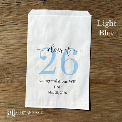 Graduation favor bags for the Class of 2026, perfect size for candy, popcorn, cookies or eating utensils.  White bags personalized for the graduate with class of 26, school name and date.