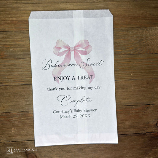 Babies are sweet enjoy a treat thank you for making my day complete.  Adorned with a pink bow and personalized for the mother to be these white bags are perfect for a candy bar or any sweet treat for your guests.  