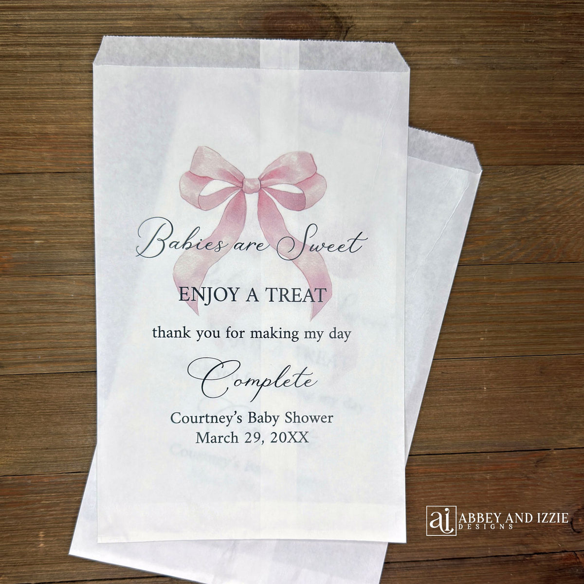 Babies are sweet enjoy a treat thank you for making my day complete.  Adorned with a pink bow and personalized for the mother to be these white bags are perfect for a candy bar or any sweet treat for your guests.  