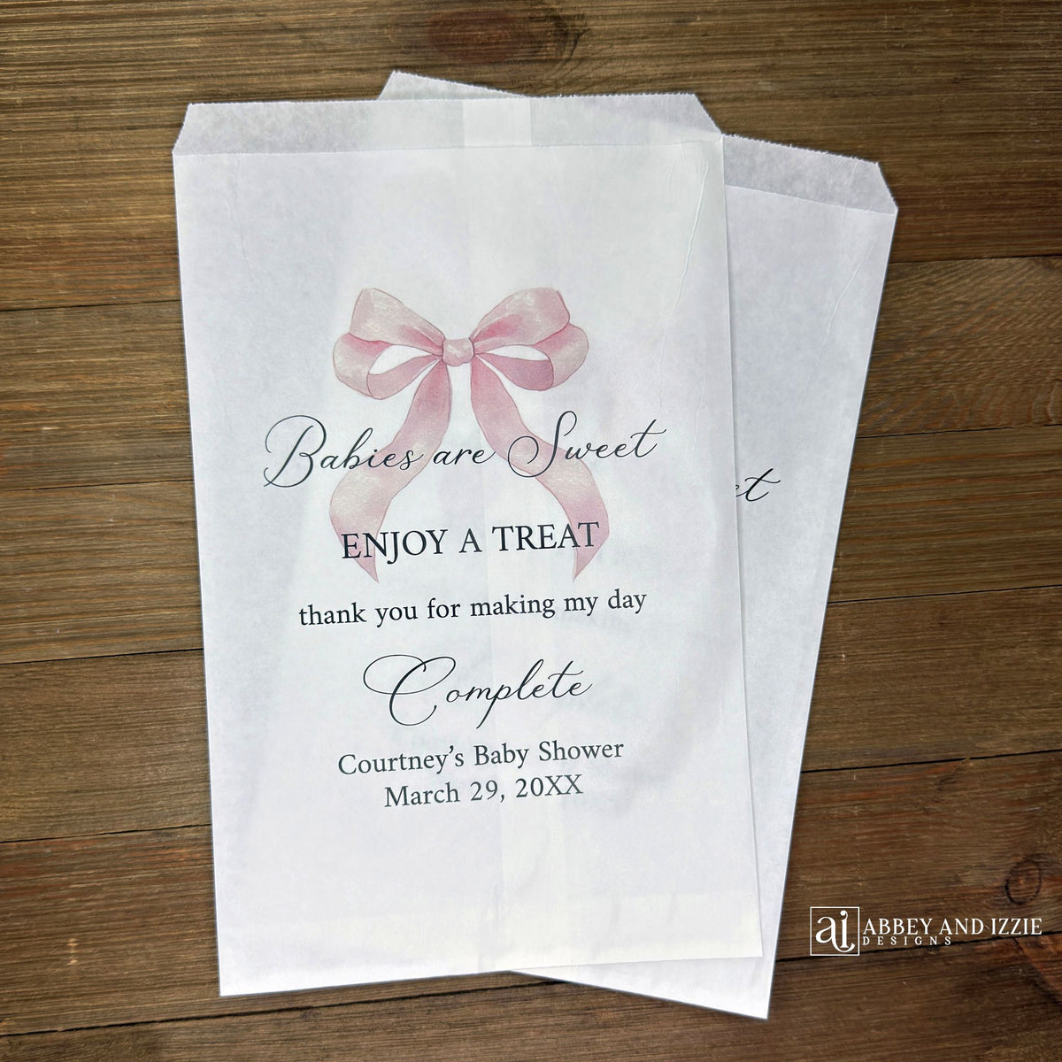 Babies are sweet enjoy a treat thank you for making my day complete.  Adorned with a pink bow and personalized for the mother to be these white bags are perfect for a candy bar or any sweet treat for your guests.  