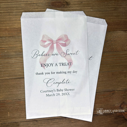 Babies are sweet enjoy a treat thank you for making my day complete.  Adorned with a pink bow and personalized for the mother to be these white bags are perfect for a candy bar or any sweet treat for your guests.  