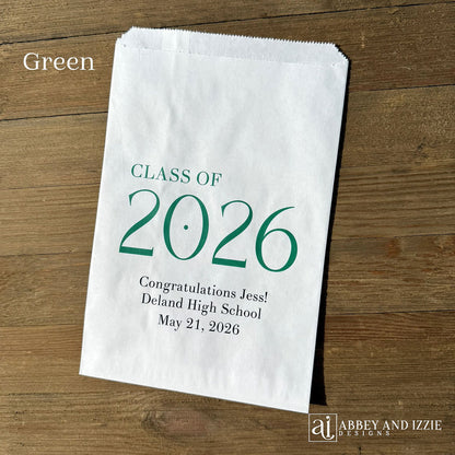 Celebrate the Class of 2026 with Personalized Favor Bags, printed on white bags with the class year in large colored print.  Honors the graudate with name and graduation date.  Your choice of class color to match your theme.  