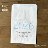 Celebrate the Class of 2026 with Personalized Favor Bags, printed on white bags with the class year in large colored print.  Honors the graudate with name and graduation date.  Your choice of class color to match your theme.  