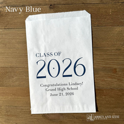Celebrate the Class of 2026 with Personalized Favor Bags, printed on white bags with the class year in large colored print.  Honors the graudate with name and graduation date.  Your choice of class color to match your theme.  
