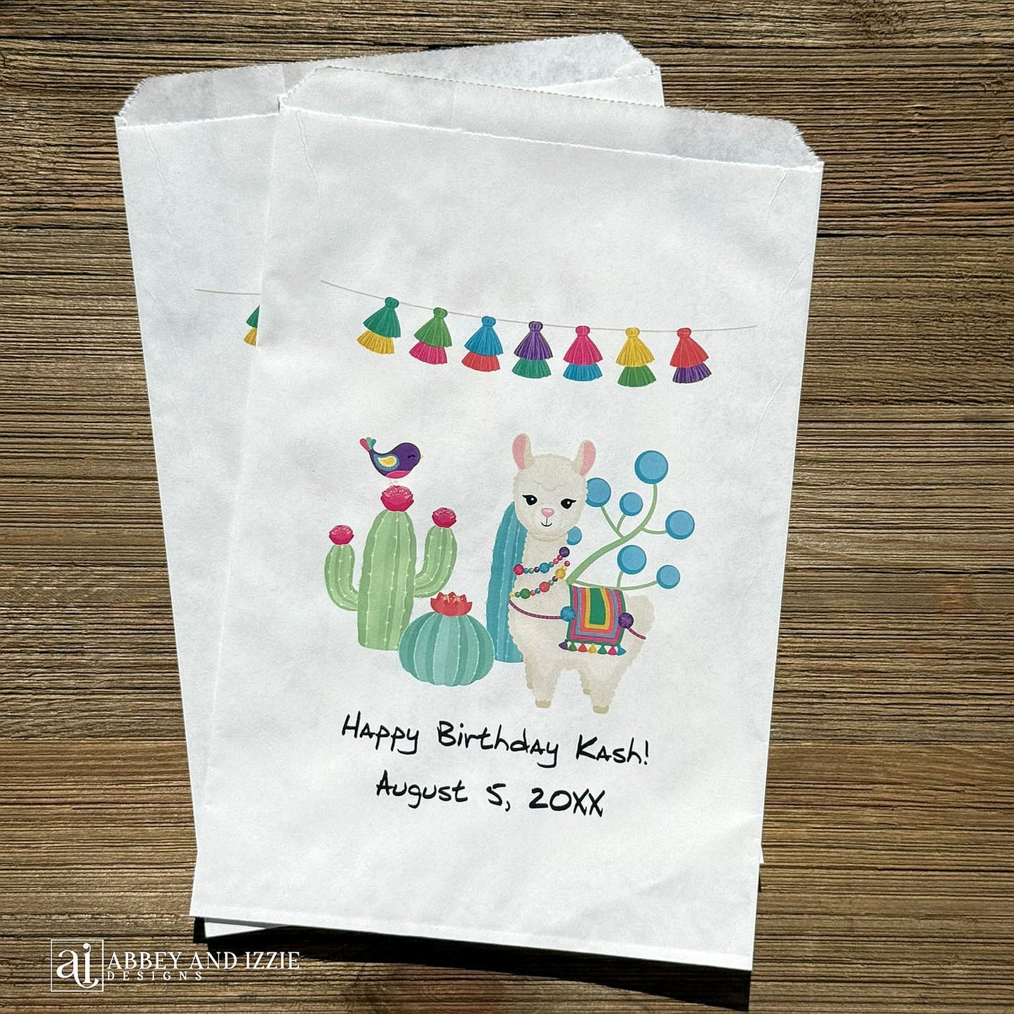Llama Birthday Party Favor Bags personalized for the guest of honor.  Printed on white bags with a colorful llama and cactus.