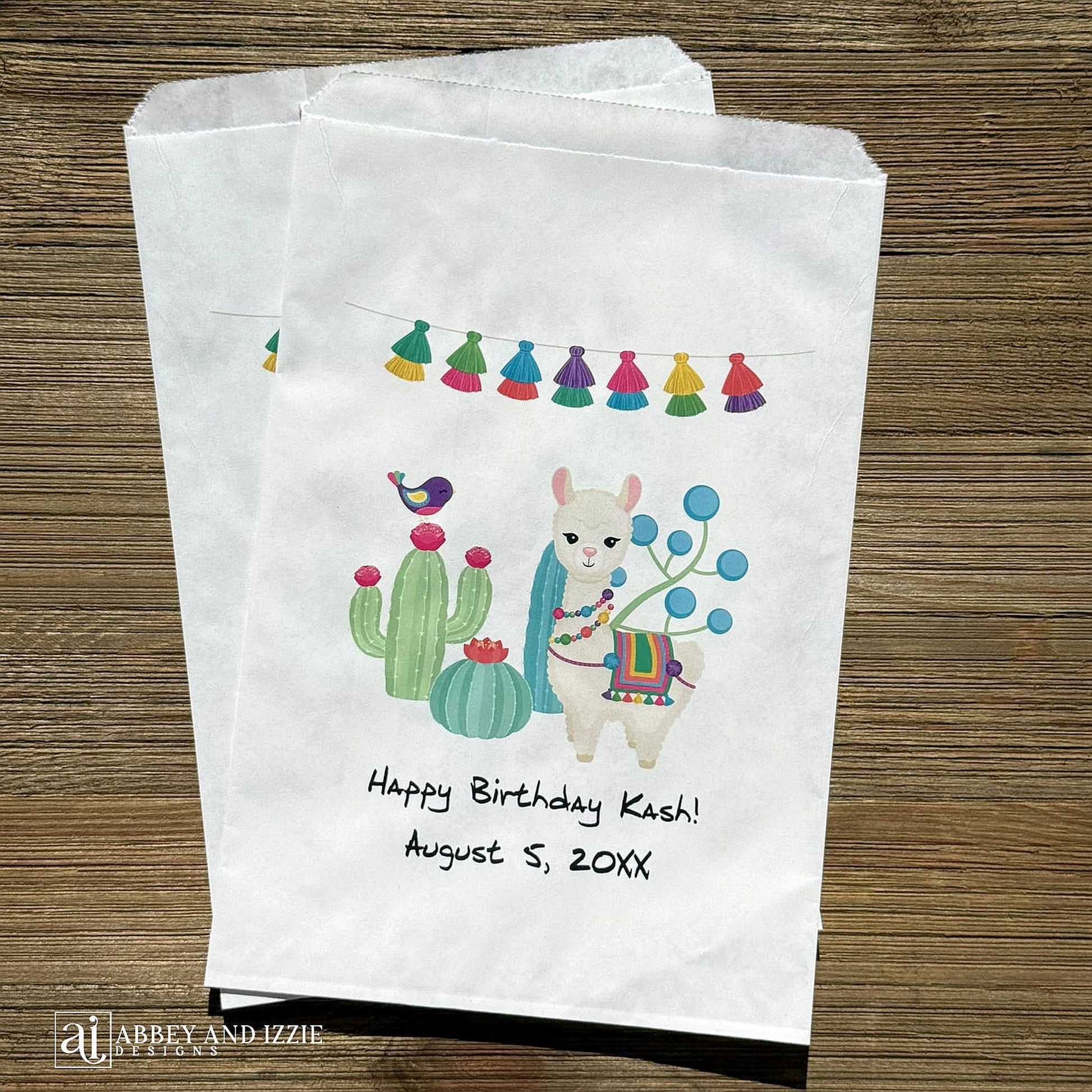 Llama Birthday Party Favor Bags personalized for the guest of honor.  Printed on white bags with a colorful llama and cactus.