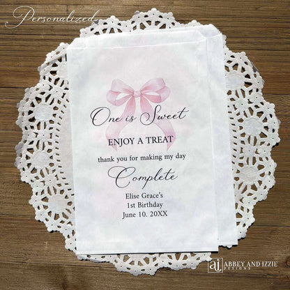 Celebrate your little one's special day with these charming , Girls Birthday Favor Bags with a Pink Bow printed on white bags , personalized for the guest of honor.