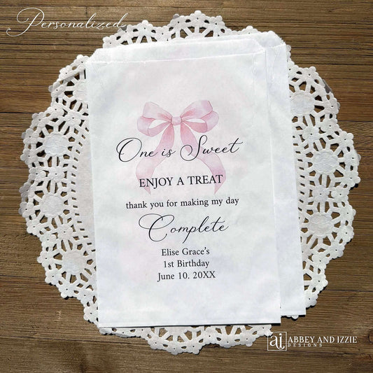 Celebrate your little one's special day with these charming , Girls Birthday Favor Bags with a Pink Bow printed on white bags , personalized for the guest of honor.