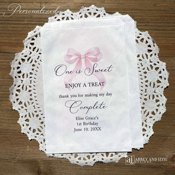Celebrate your little one's special day with these charming , Girls Birthday Favor Bags with a Pink Bow printed on white bags , personalized for the guest of honor.