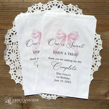 Celebrate your little one's special day with these charming , Girls Birthday Favor Bags with a Pink Bow printed on white bags , personalized for the guest of honor.