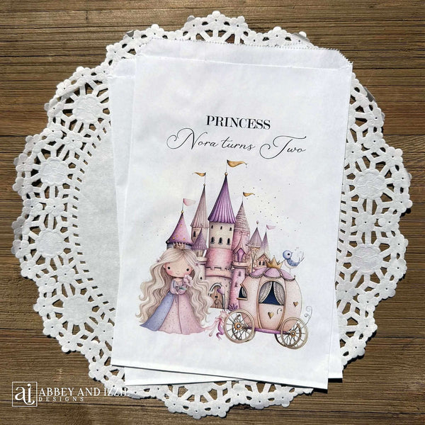 Princess Party Candy Bags printed on white paper bags and personalized with 'PRINCESS (your name) turns (your age).  Adorned with a sweet princess standing in front of her castle  and carriage, all in hints of pink and purple.  Bags are larger than most and will fit all kinds of fun goodies.
